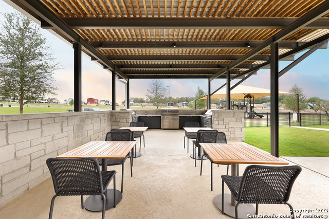 5386 Ranch Road 1376, Unit 191 Fredericksburg, TX 78624 - Photo 23 of 23 a view of a patio with a table chairs and a backyard