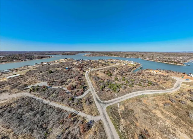 an aerial view of a house with a lake view