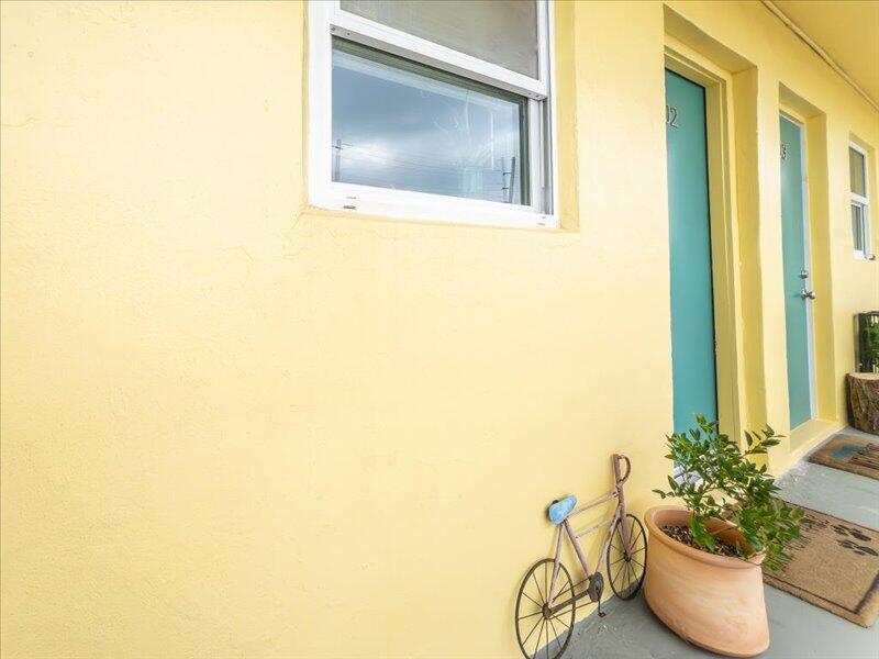 201 Coppitt Road, Unit 202A Key West, FL 33040 - Photo 12 of 21 a living room with a couch and potted plant
