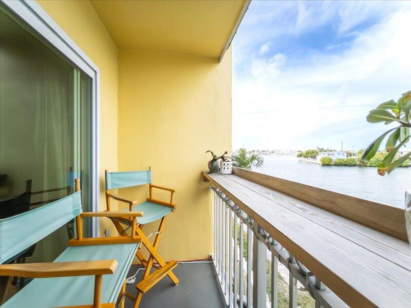 201 Coppitt Road, Unit 202A Key West, FL 33040 - Photo 14 of 21 a view of balcony with two chairs and a potted plant