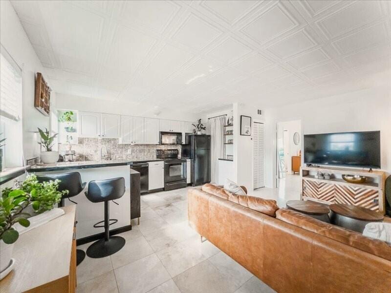 201 Coppitt Road, Unit 202A Key West, FL 33040 - Photo 2 of 21 a living room with furniture and a flat screen tv