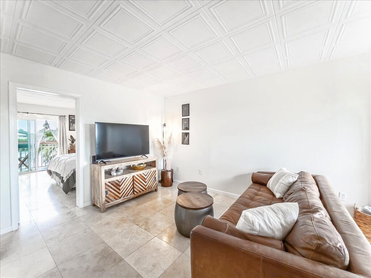 201 Coppitt Road, Unit 202A Key West, FL 33040 - Photo 3 of 21 a living room with furniture and a flat screen tv