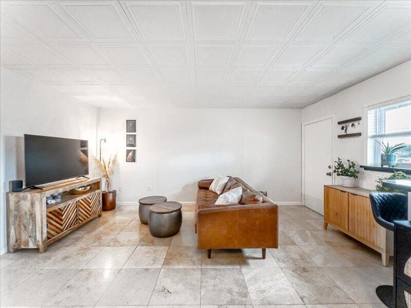 201 Coppitt Road, Unit 202A Key West, FL 33040 - Photo 4 of 21 a living room with furniture and a flat screen tv