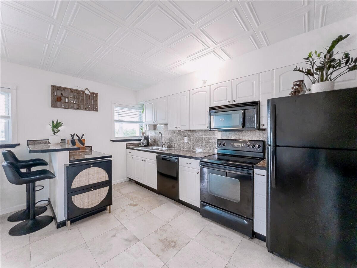 201 Coppitt Road, Unit 202A Key West, FL 33040 - Photo 6 of 21 a kitchen with stainless steel appliances a stove a sink and a refrigerator