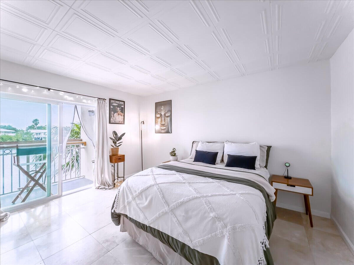 201 Coppitt Road, Unit 202A Key West, FL 33040 - Photo 9 of 21 a bedroom with a bed and a table