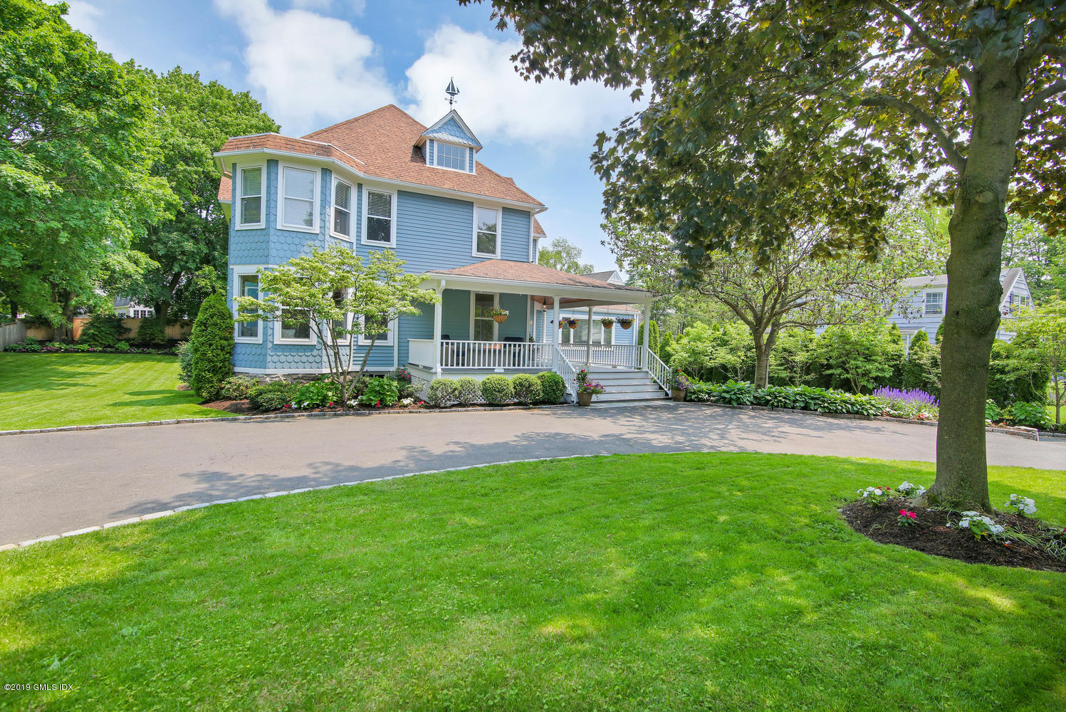 115 Riverside Avenue Riverside, CT 06878 - Photo 1 of 28 a front view of a house with a yard and green space