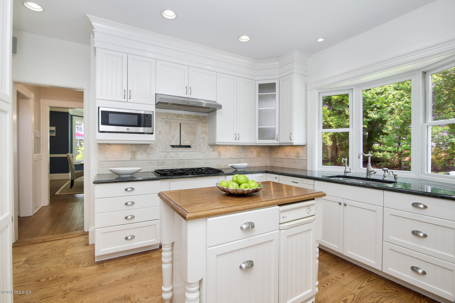 115 Riverside Avenue Riverside, CT 06878 - Photo 12 of 28 a kitchen with granite countertop white cabinets and window