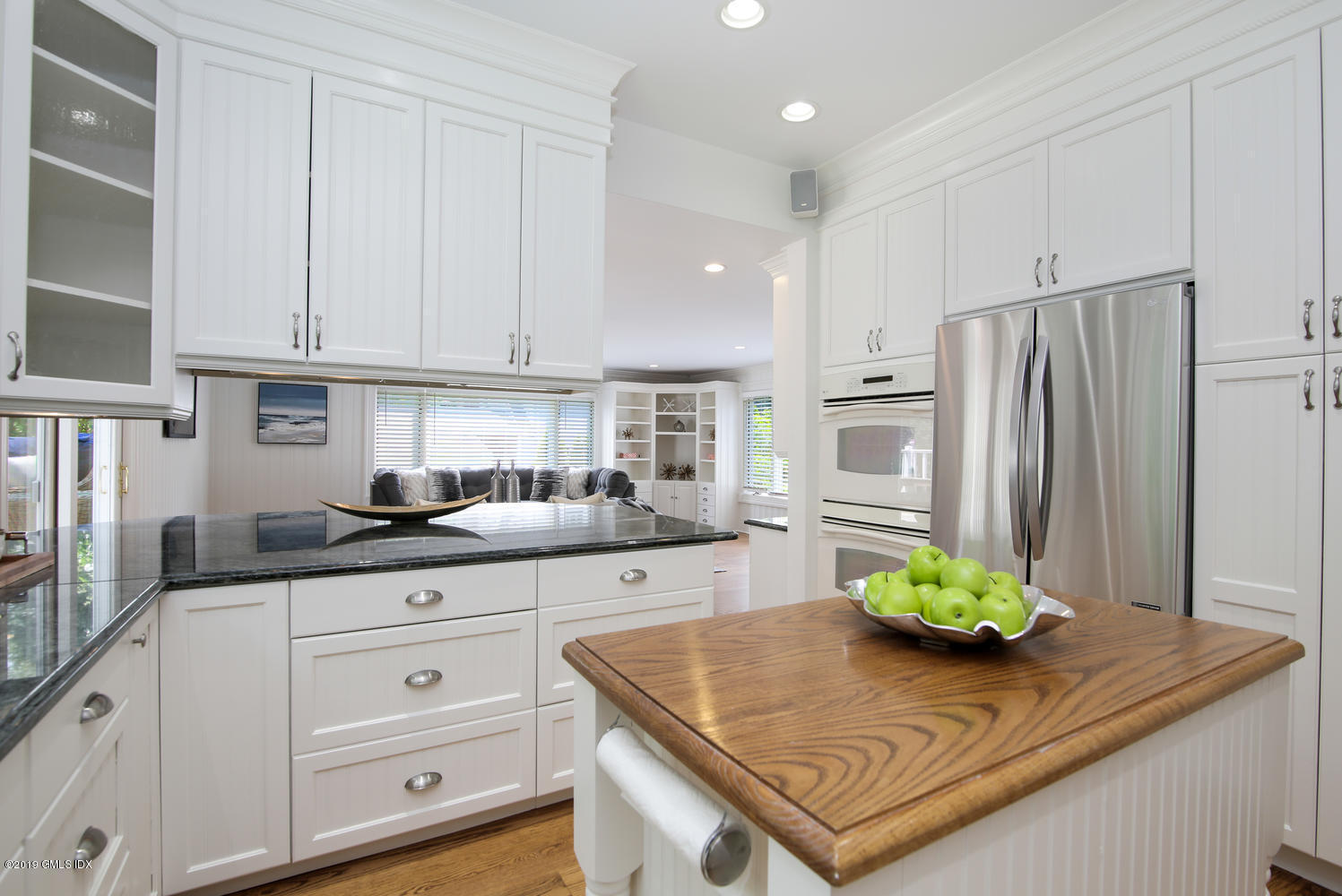 115 Riverside Avenue Riverside, CT 06878 - Photo 14 of 28 a kitchen with stainless steel appliances granite countertop a white refrigerator a sink and white cabinets