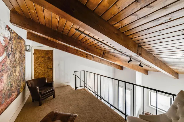 a bathroom with a granite countertop sink toilet and mirror