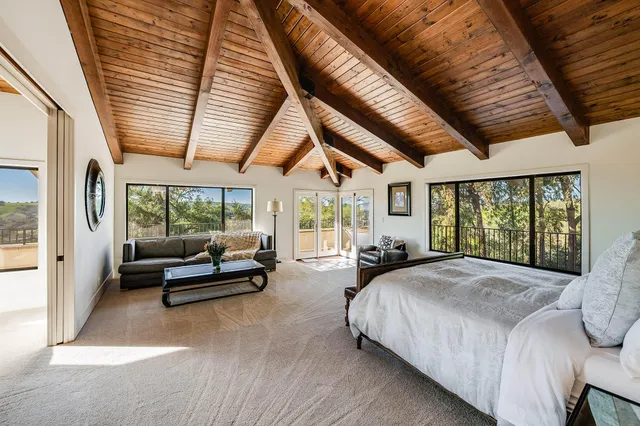a view of backyard with swimming pool and outdoor seating