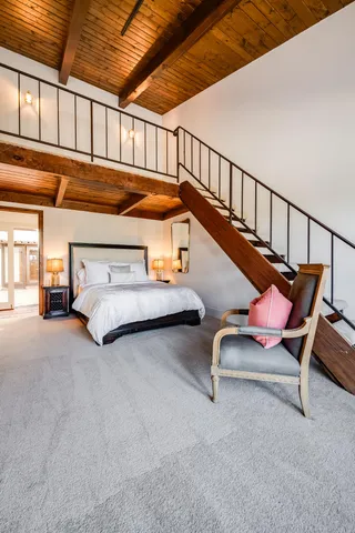 a spacious bathroom with a double vanity sink a large mirror and a shower