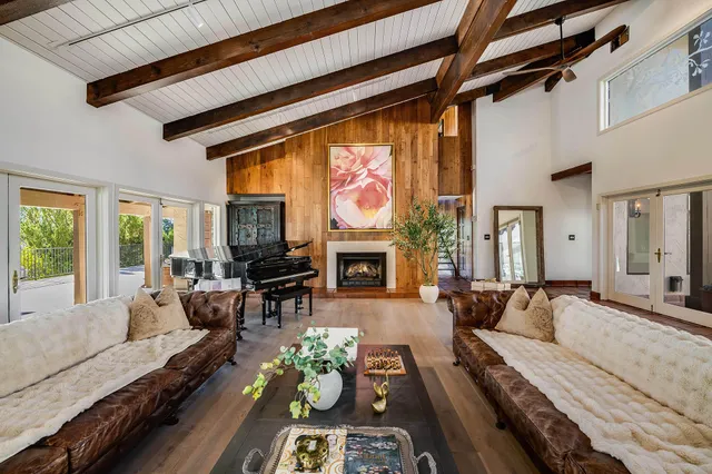a living room with furniture fireplace and flat screen tv