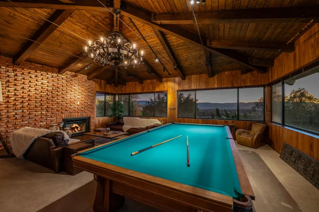an aerial view of a house with a garden and lake view