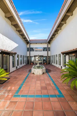 an aerial view of a house with a garden and lake view