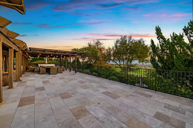 an aerial view of residential houses with outdoor space and lake view
