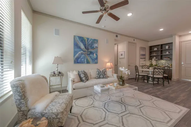 a living room with furniture and wooden floor