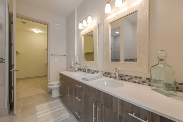a bathroom with a double vanity sink mirror and double