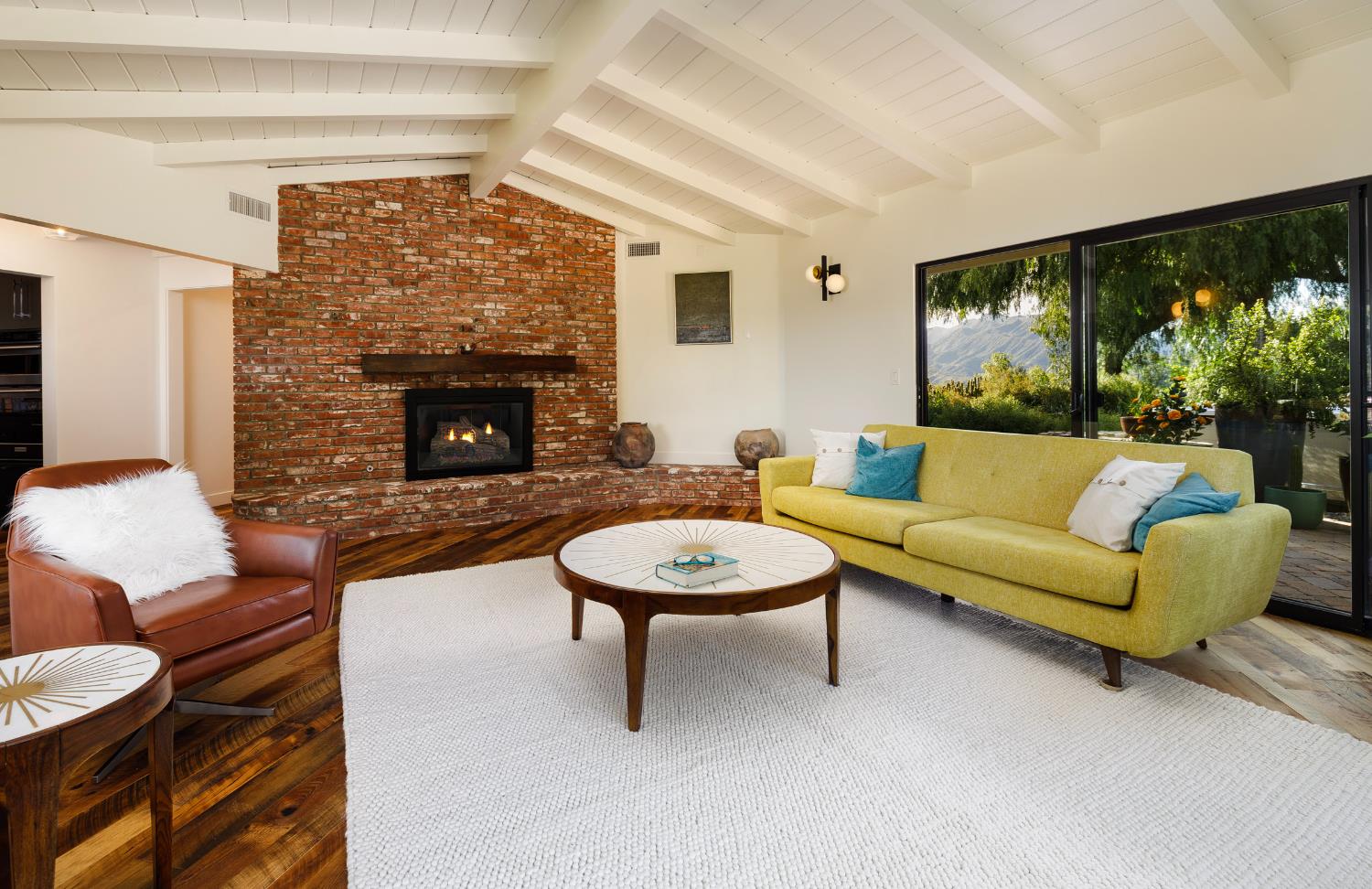 1417 Foothill Road Ojai, CA 93023 - Photo 9 of 41 a living room with furniture a fireplace and a flat screen tv