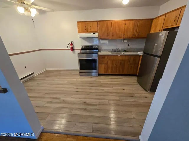 a kitchen with a refrigerator and a sink