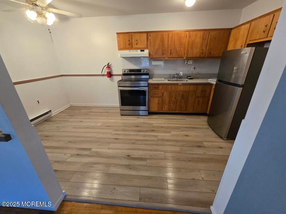 a kitchen with a refrigerator and a sink
