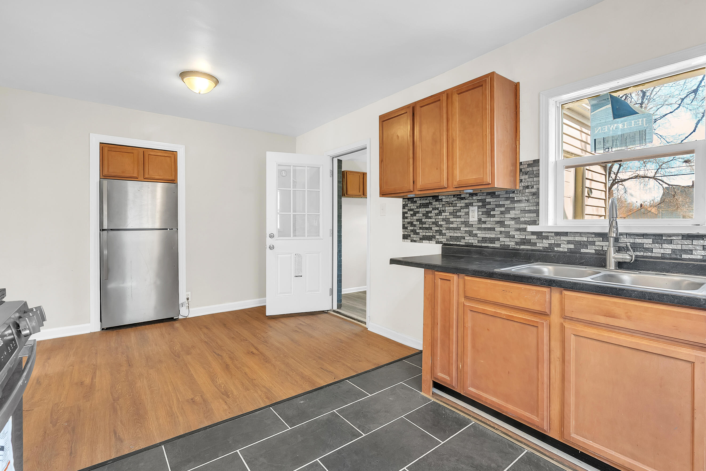 263 Rutledge Street Gary, IN 46404 - Photo 11 of 21 a room with kitchen island granite countertop a sink cabinets and stainless steel appliances