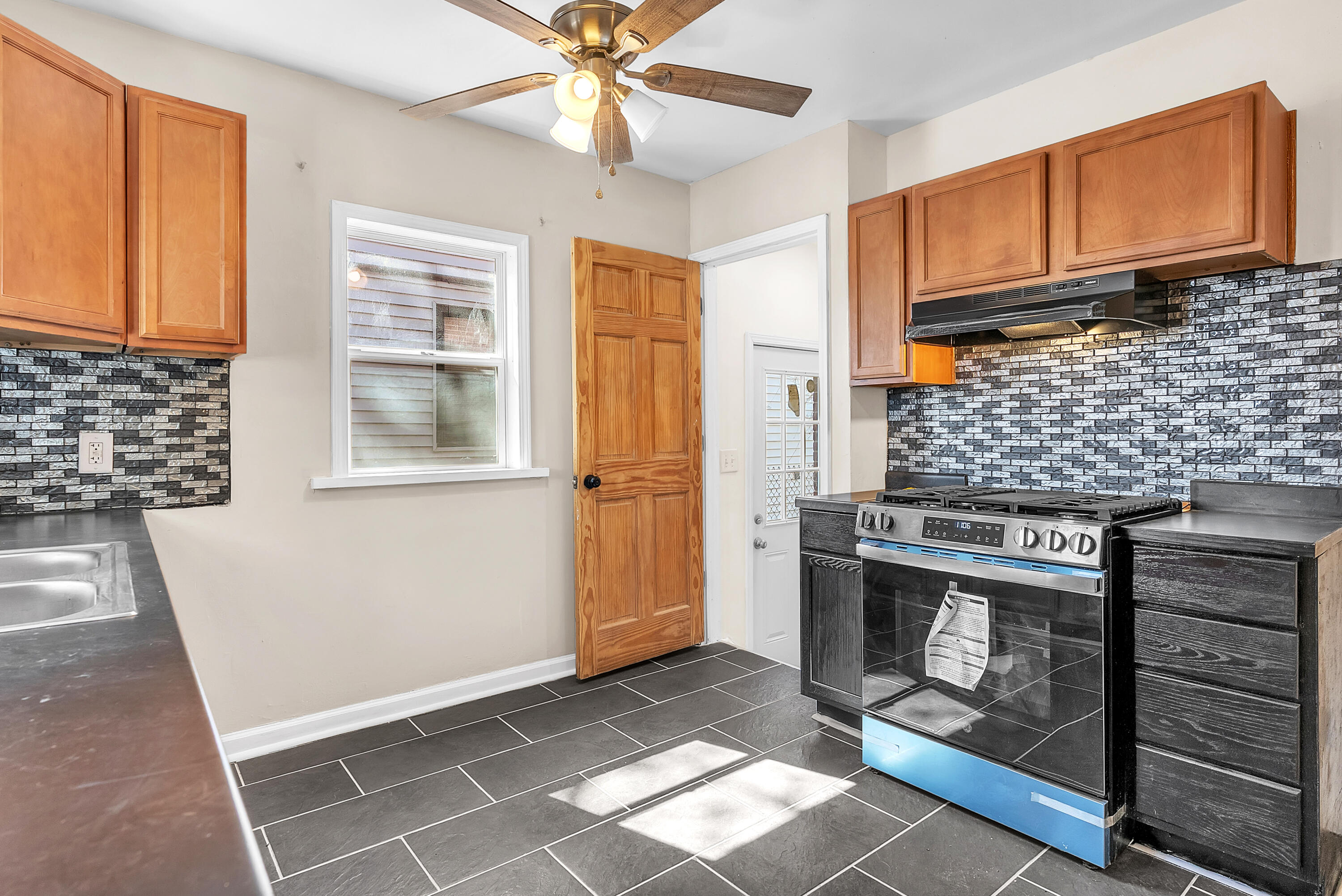 263 Rutledge Street Gary, IN 46404 - Photo 13 of 21 a kitchen with stainless steel appliances granite countertop a stove top oven a sink and a cabinets