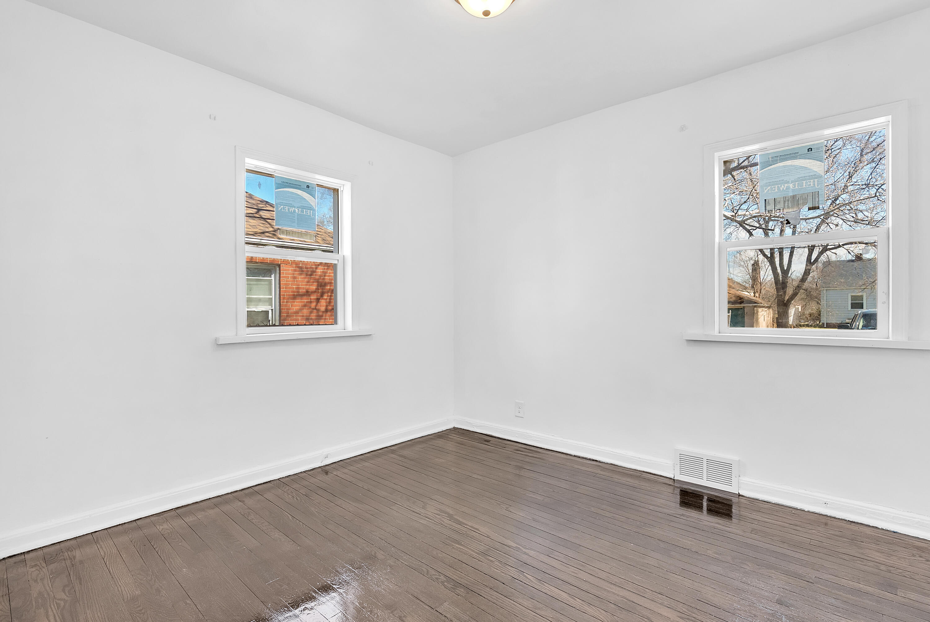 263 Rutledge Street Gary, IN 46404 - Photo 14 of 21 a view of an empty room with wooden floor and a window