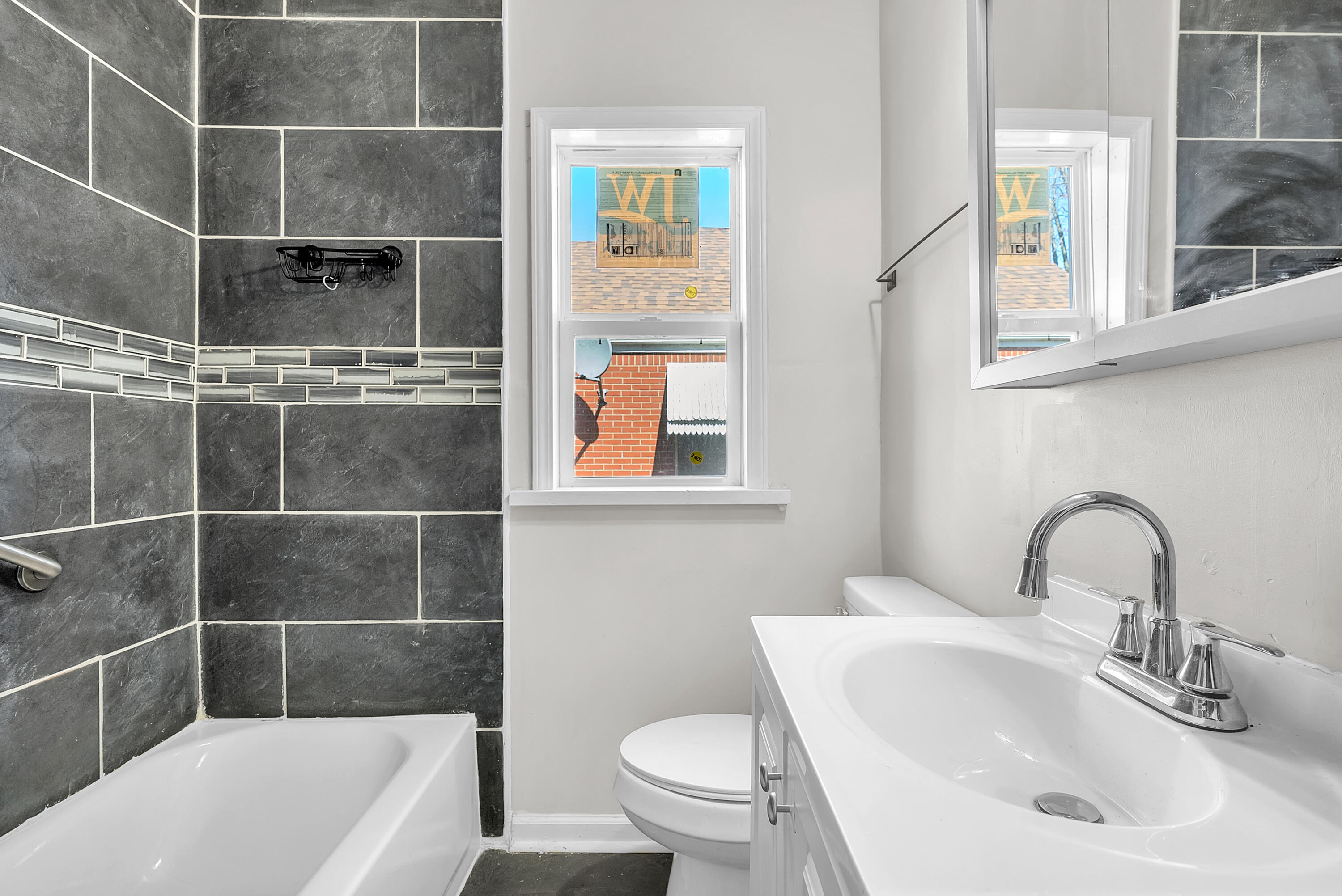 263 Rutledge Street Gary, IN 46404 - Photo 15 of 21 a bathroom with a sink a toilet and shower