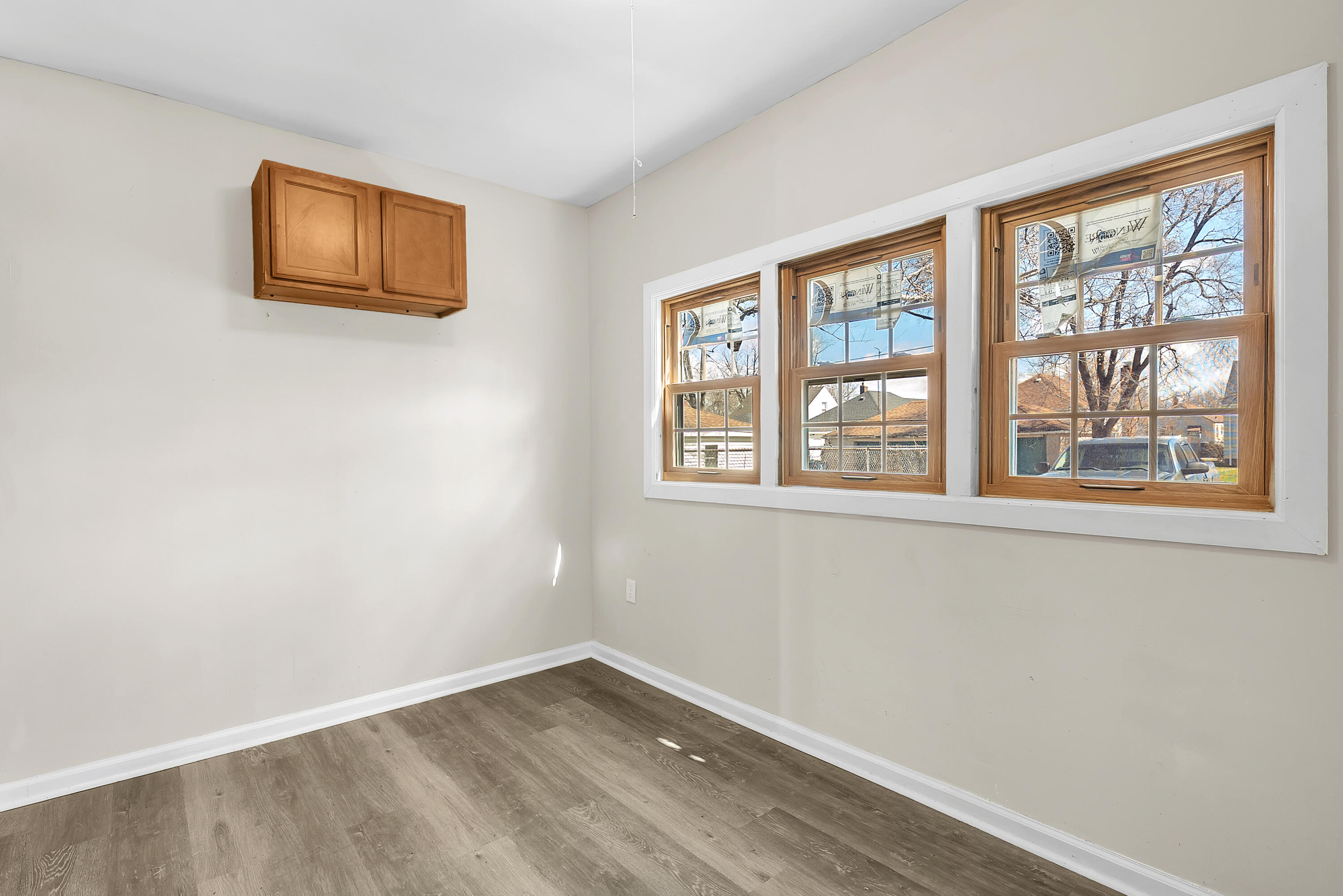 263 Rutledge Street Gary, IN 46404 - Photo 19 of 21 a view of an empty room with a window and wooden floor