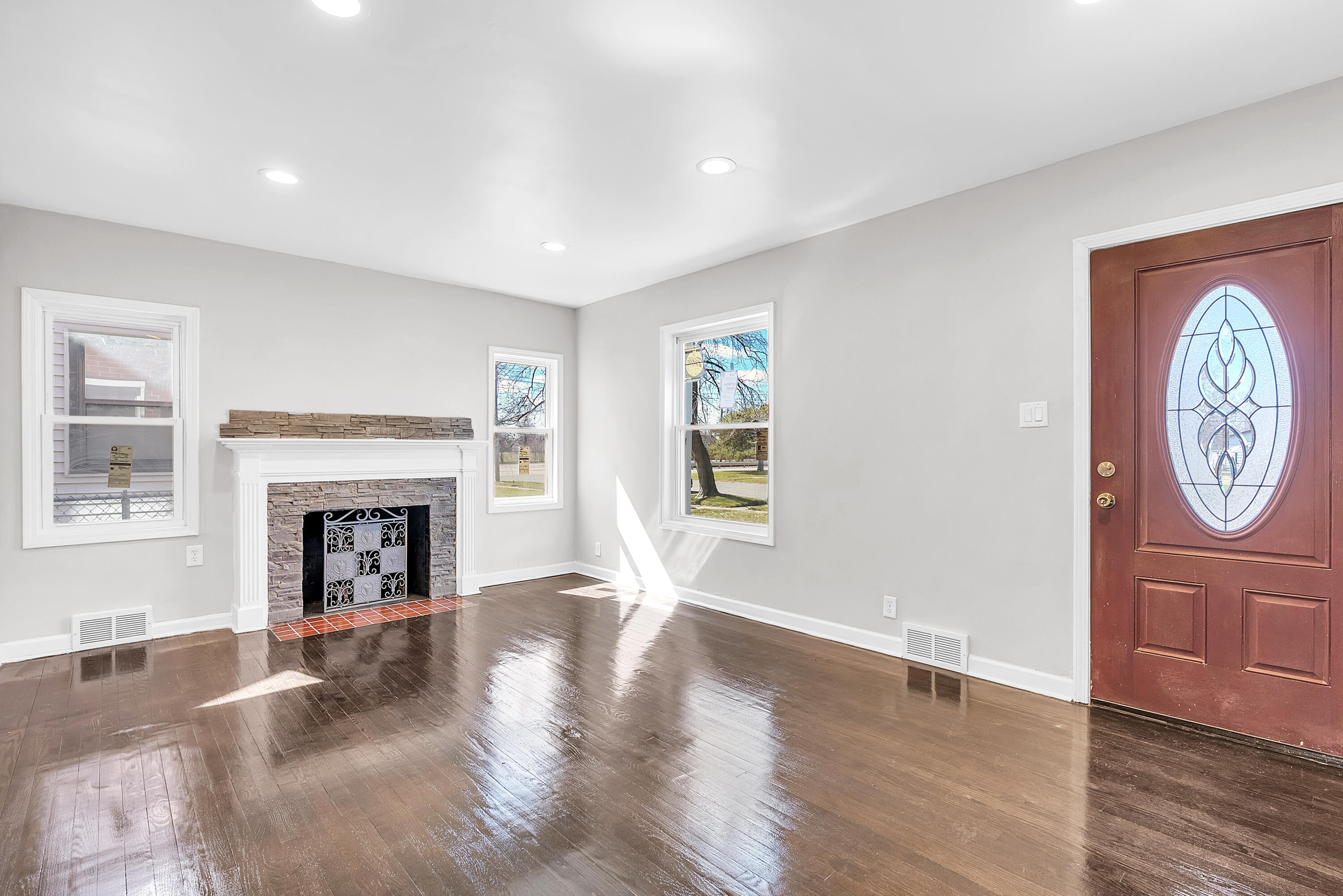 263 Rutledge Street Gary, IN 46404 - Photo 6 of 21 a view of a livingroom with a fireplace window and wooden floor