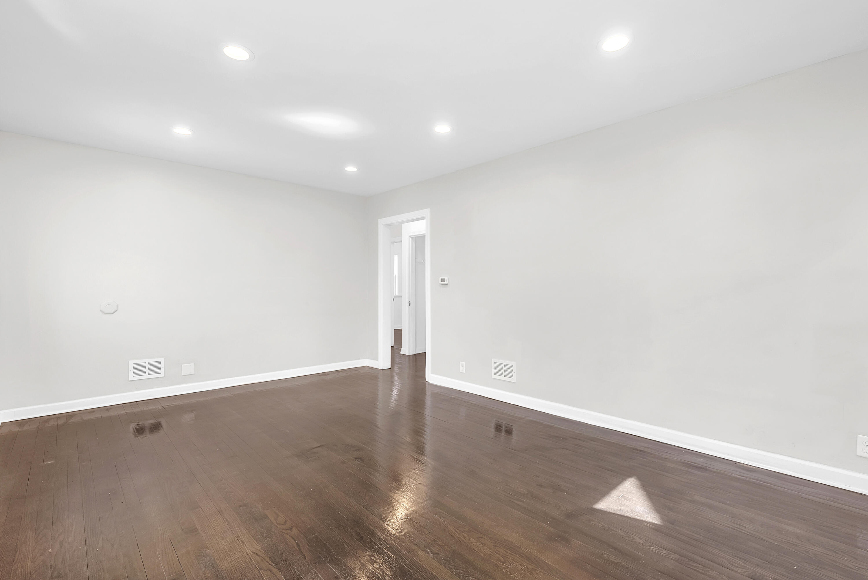 263 Rutledge Street Gary, IN 46404 - Photo 8 of 21 an empty room with wooden floor and windows