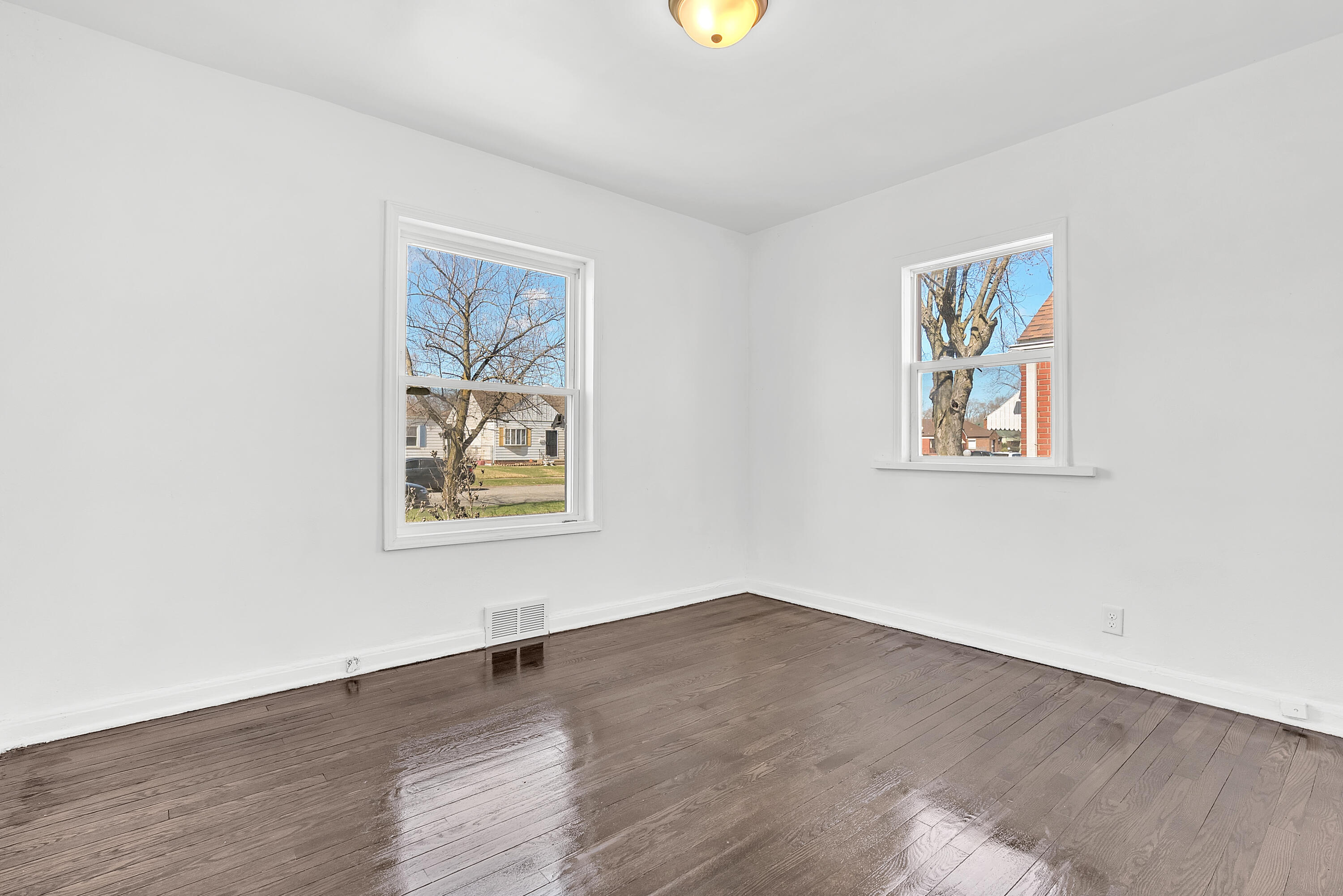 263 Rutledge Street Gary, IN 46404 - Photo 9 of 21 an empty room with a window and wooden floor