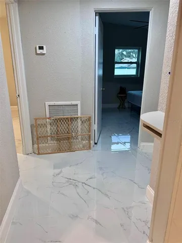 a view of an empty room with a window