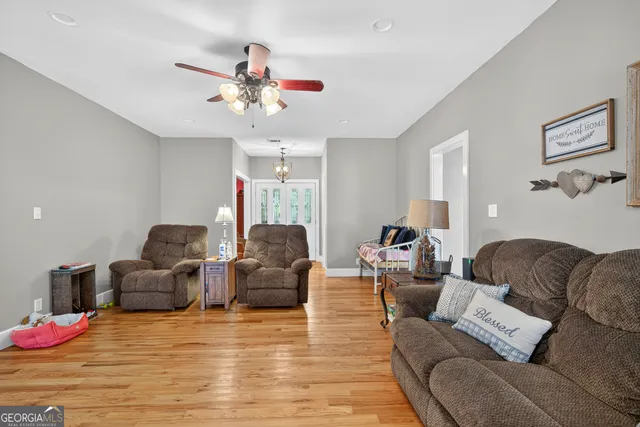 a view of a dining room with furniture and chandelier