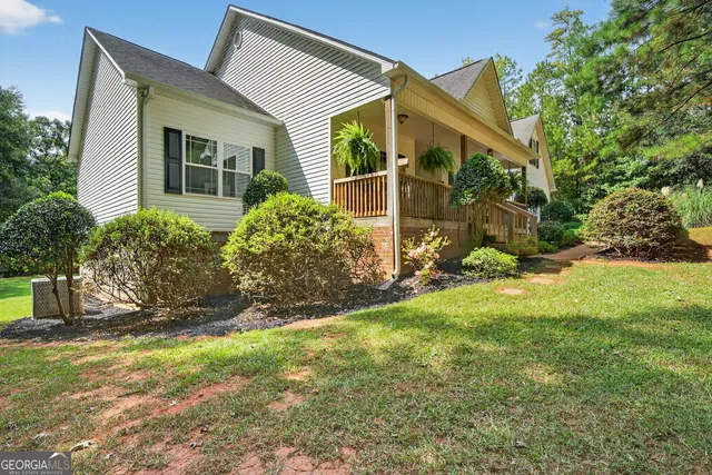 a aerial view of a house with a yard and potted plants
