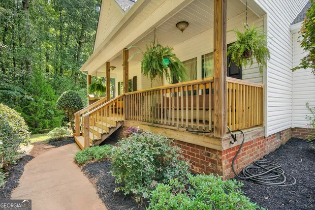 a living room with furniture chandelier and a wooden floor