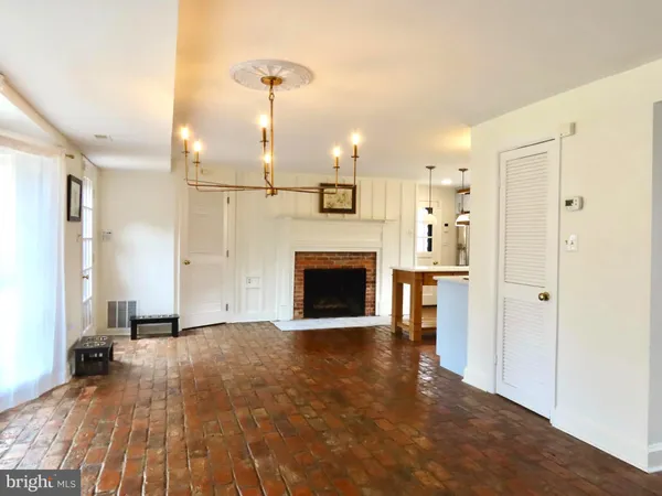 a view of a livingroom with a fireplace and window