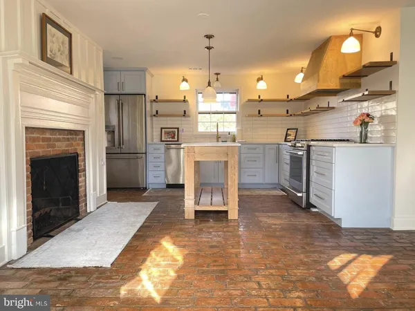 a kitchen with refrigerator and cabinets