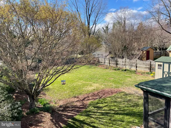 a view of yard with swimming pool and green space