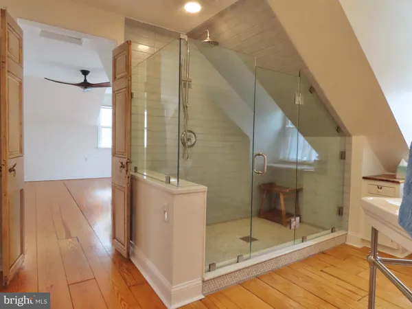 a bathroom with a glass shower door and a sink