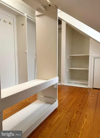 a view of a room with wooden floor and closet