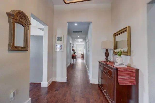 a view of a hallway and wooden floor