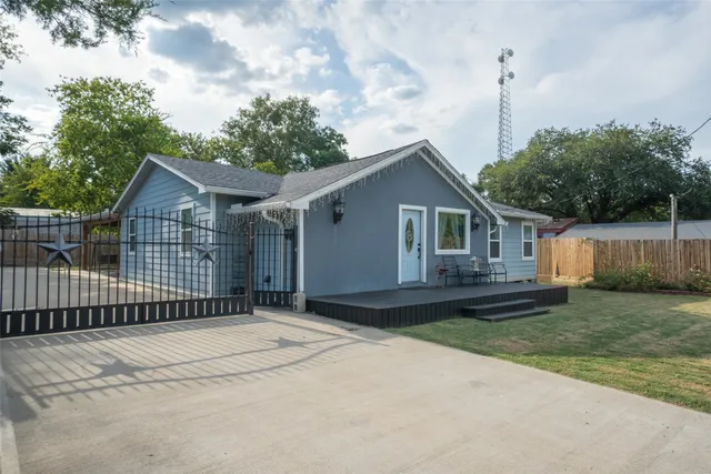 a front view of a house with a garden and yard
