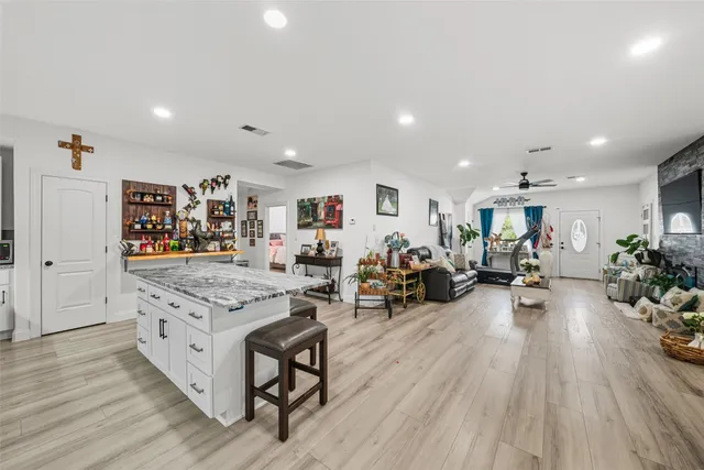 a very nice looking living room with wooden floor and furniture