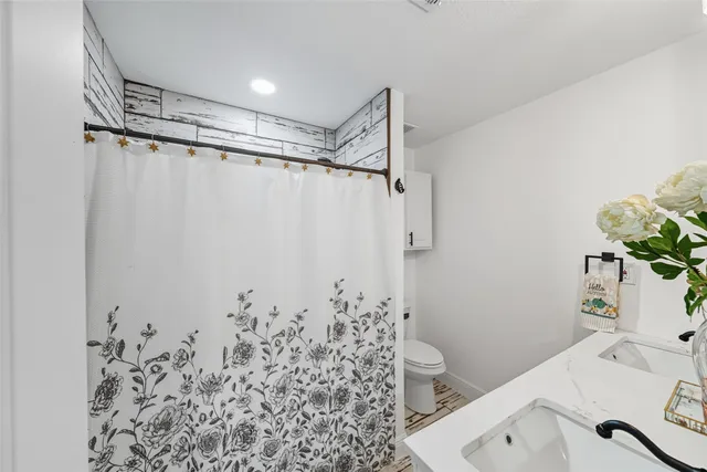 a bathroom with a sink toilet and shower