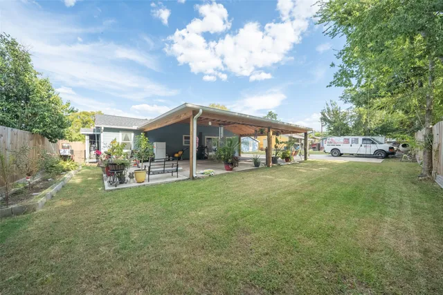 a view of a house with backyard porch and sitting area