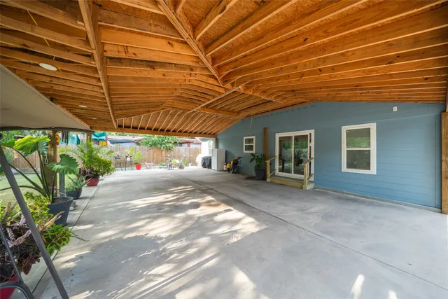 a view of a backyard with plants and a patio