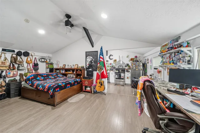 a view of a room with gym equipment and a flat screen tv