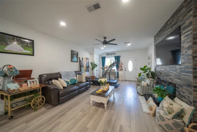 a living room with furniture and a wooden floor