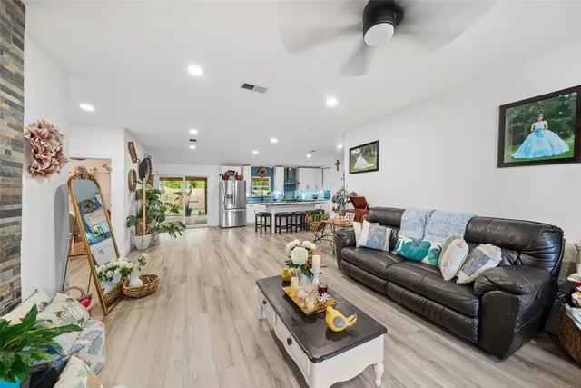 a living room with furniture and a wooden floor